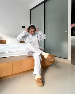 Close-up of gray hooded tracksuit set with matching joggers and plush platform slippers