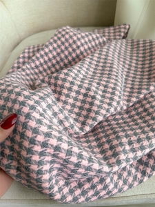 Close-up of the vintage houndstooth pattern in pink and grey on this soft cashmere scarf