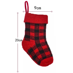 Detail showing red and black plaid knitted Christmas stocking with 20cm height dimension