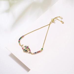 Adjustable gold dolphin bracelet with colorful zircon stones in a minimalist design