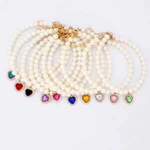 Elegant pearl pet necklace with heart-shaped gemstone pendants in eleven vibrant colors