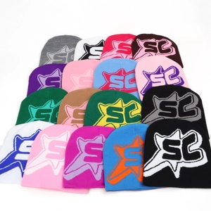 Multiple colorful knit beanies with star letter logo in a stacked street style layout