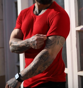 Detailed close-up of men's red slim-fit ribbed t-shirt showing elastic fabric texture
