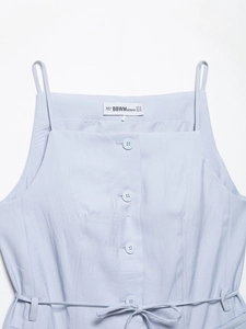 Detail of light blue button-up camisole with decorative ties and brand label in size S