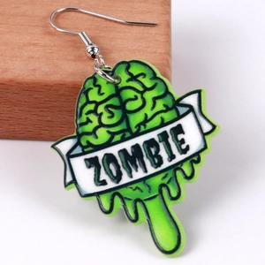 Macro view of green zombie brain acrylic earring with white banner text and metal hook