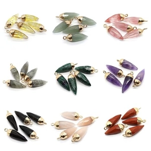 Macro display of diverse 15x20mm natural stone cube pendants with gold bail connectors