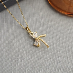 Macro shot of gold-plated butterfly necklace with sparkling zircon and drop-shaped stones
