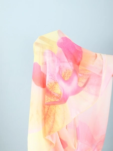 Detailed macro view of the semi-transparent mesh fabric with pink and yellow floral prints