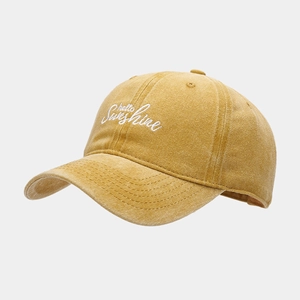 Detail of vintage yellow washed cotton baseball cap with hello sunshine embroidery