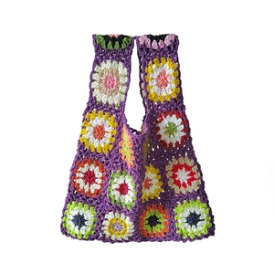 Detailed macro view showing the intricate crochet texture and colorful sunflower patterns
