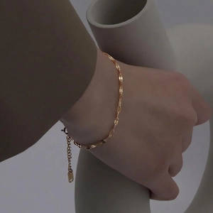 Minimalist gold titanium steel lip chain bracelet with shimmering water ripple texture