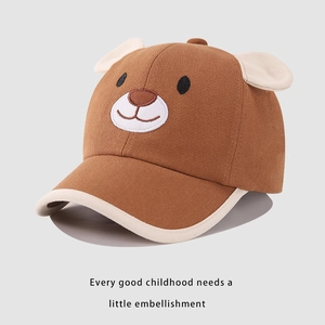 Close-up of brown cotton baseball cap with cute embroidered bear face and soft 3D ears