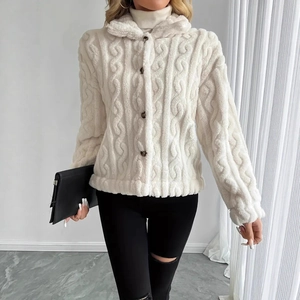 Detail of white plush cropped jacket featuring a textured cable knit pattern and button closure