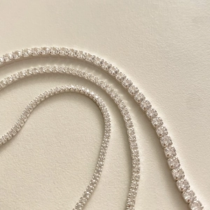 Macro detail of silver tennis bracelets with round and square cut zircon stones