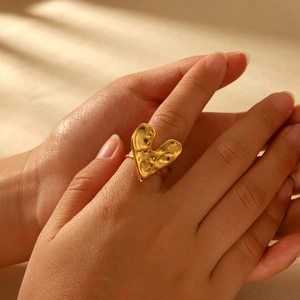 Elegant 18K gold plated stainless steel heart ring with textured finish on model hand