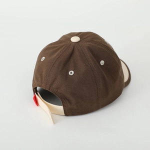 Rear view of brown and beige patchwork baseball cap showing adjustable strap detail