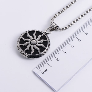 Vintage punk style stainless steel sun pendant necklace with sunburst pattern on white background