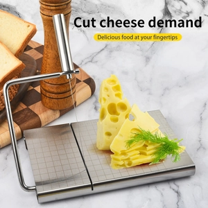 Stainless steel cheese slicer with wire cutter and scale base on marble countertop