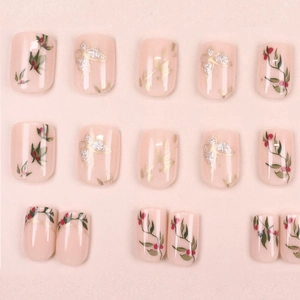 Short square press-on nails with pink base, green vines, red berries, and gold butterfly