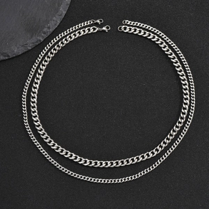 Double-layered silver stainless steel twist chain necklace on black background