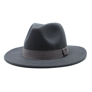 Close-up of a dark grey wool fedora hat featuring a classic indented crown and ribbon trim