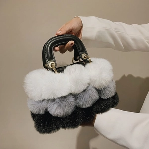 Close-up of tricolor plush faux fur handbag featuring premium leather handles and gold buckles