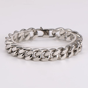 Polished silver stainless steel Cuban link bracelet displayed on a clear acrylic stand