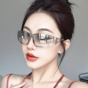 Close-up of metallic hollow square sunglasses with silver frames and gradient brown lenses