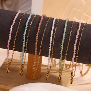 18K gold plated bead anklets with colorful natural stones on a display stand