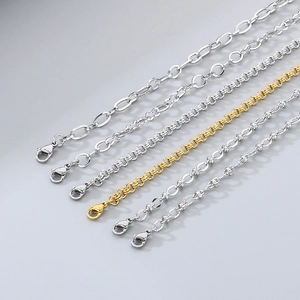 Detail of assorted gold and silver stainless steel chains with lobster clasps