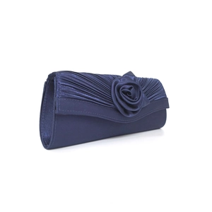 Detail of dark blue satin evening clutch featuring handmade fabric flower decorations