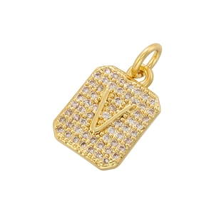 Macro shot of gold square pendant with cubic zirconia inlay featuring 3D letter V