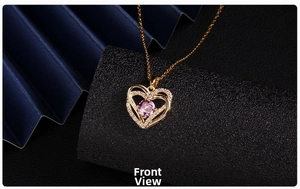 Front view close-up of gold heart pendant necklace with purple zircon and sparkling crystals