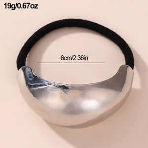 Detailed view of 6cm black elastic hair tie with large crescent-shaped silver metal accent