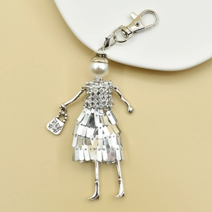 Detail of handmade doll keychain with white faux pearl head and sparkling rhinestone body