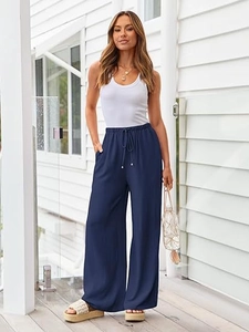 Detail of navy blue wide-leg trousers with adjustable drawstring and elastic waistband
