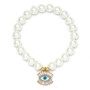 Detailed close-up of shell pearl bracelet with a golden evil eye charm and inlaid stones