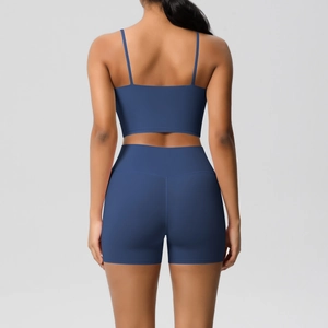 Rear view detail of dark blue yoga set with strappy sports bra and high waist shorts