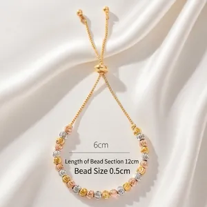 Elegant 18k gold bead bracelet with tricolor faceted metal beads and silk background