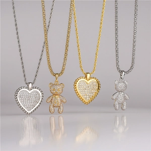 Gold and silver bear and heart pendant necklaces with micro-paved zircons in a group view