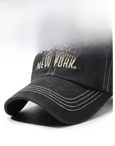 Detailed view of white NEW YORK embroidery on washed cotton vintage baseball cap