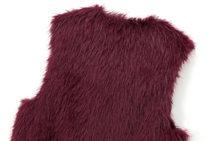 Close-up of wine red faux fur vest showing detailed fiber texture and soft neckline finish
