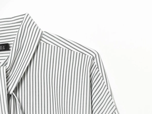 Detailed view of striped poplin shirt neckline with elegant scarf tie design