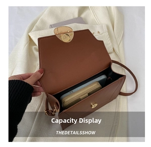 Top view of brown leather bag interior showing capacity for phone and wallet