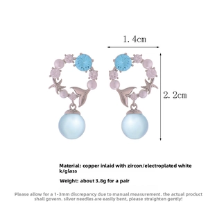 Detail view showing blue zircon mermaid tail earrings with silver plating and glass beads