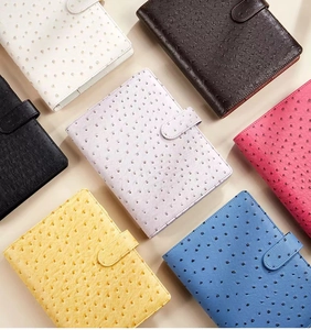 Close-up showing various colors of ostrich texture PU leather binders with U-buckle closure