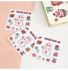 Detail of cute cartoon stickers with bear and rabbit motifs on a pink and white background