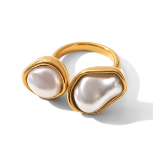 Detailed close-up of golden stainless steel ring with two irregular baroque pearls