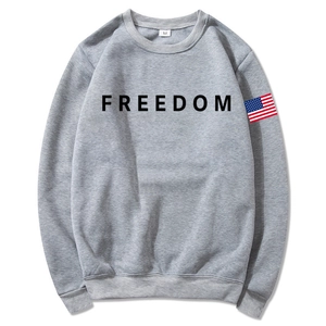 Unisex grey hoodie with black Freedom print and American flag sleeve badge, flat lay view