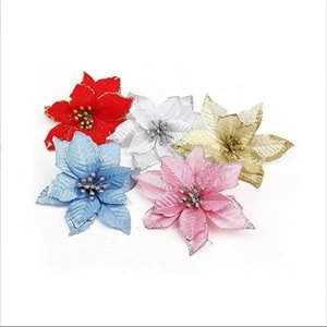 Close-up of artificial poinsettia flowers with glitter edges for Christmas tree decor